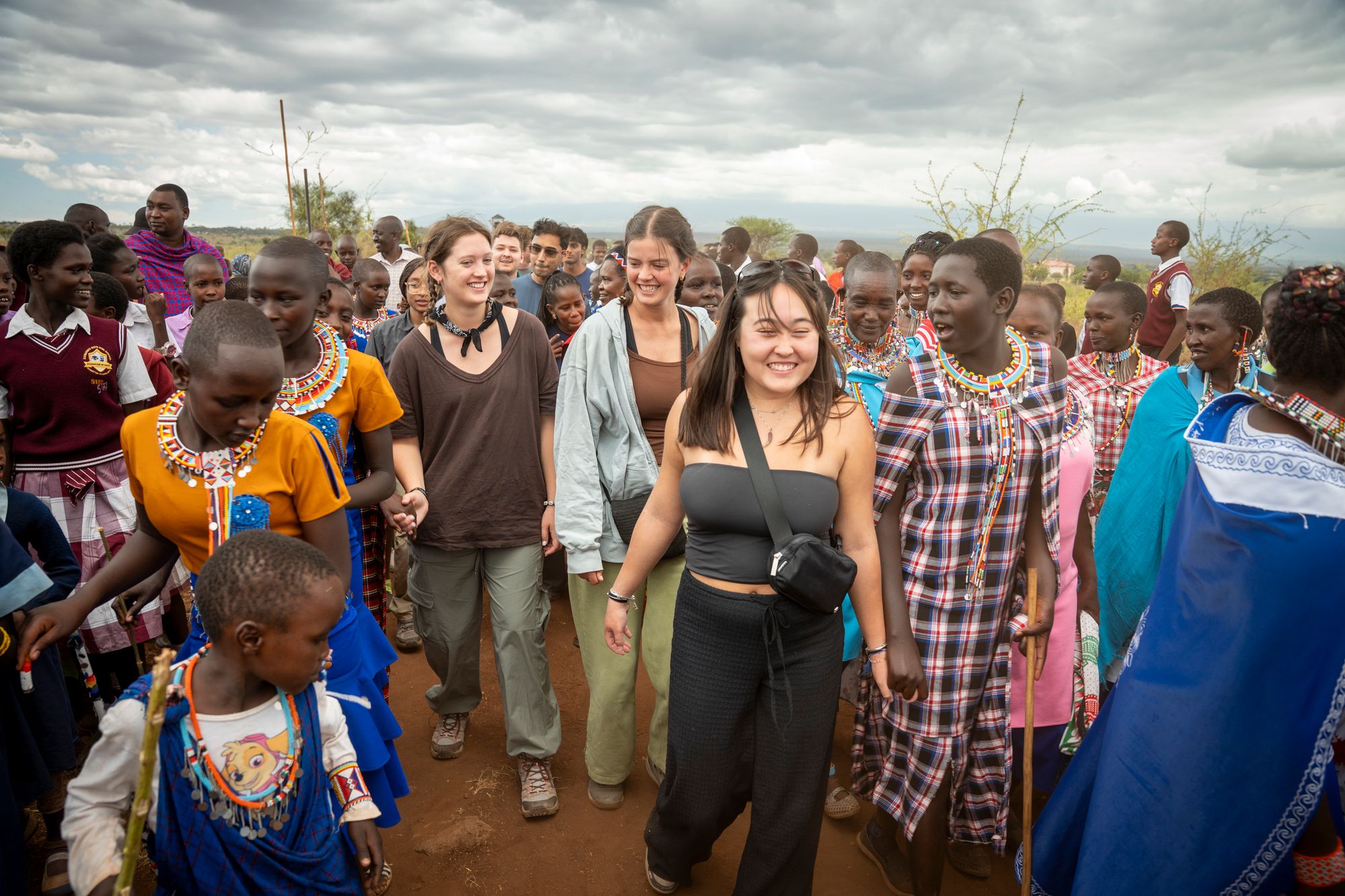 UT Austin students walking with members of the Maasai community in Kenya